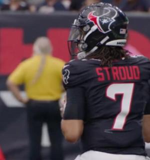 a football player standing in front of a referee