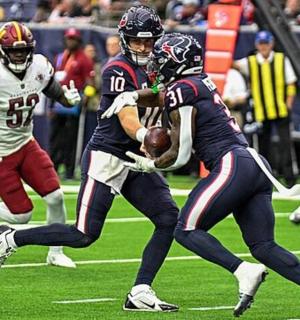 a football player intercepts a ball during a game