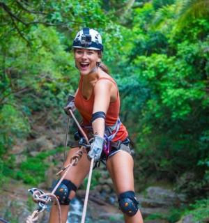 a woman riding a bike on a zip line
