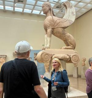 a group of people looking at a statue in a museum