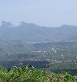 a view of a valley with mountains in the background