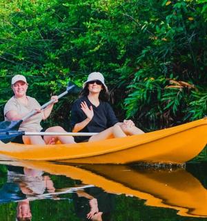 a man and a woman in a yellow boat on the water