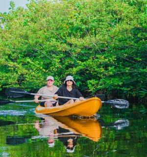 a man and woman in a canoe on a river