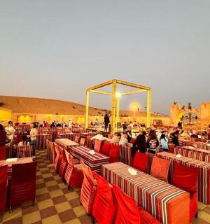 a group of people sitting in red chairs