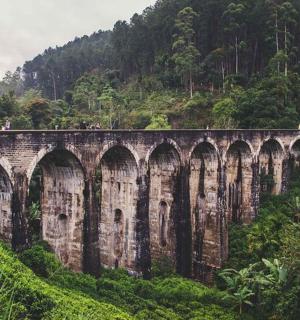 a bridge with many arches on a mountain