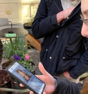 a woman is looking at a cell phone