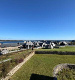 a group of houses in a field next to the water