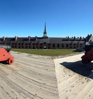 a large cannon sitting on top of a building