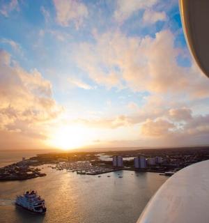 a view of a ship in the water with the sunset