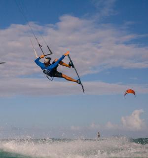 a man flying through the air over the ocean