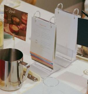 a table with a tea kettle and certificates on it