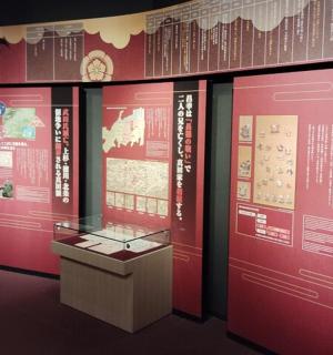 a display case in a museum withinese writing on the wall