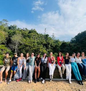 a group of people posing for a picture on a bridge