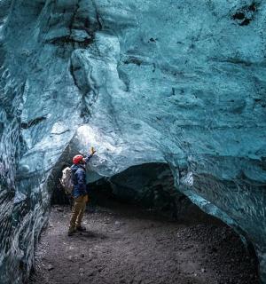 a man is standing in an ice cave