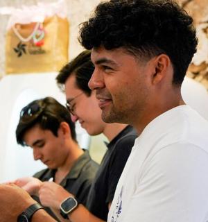 a group of men looking at a cell phone