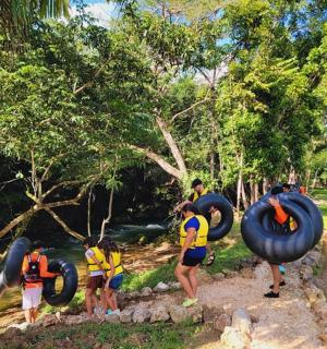 a group of people with tires on a river