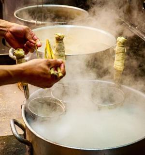 a person is cooking food in a pot