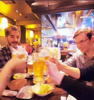a group of people sitting at a table with drinks