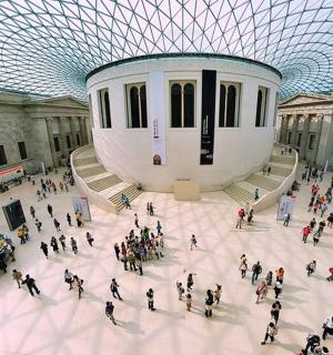 a large group of people walking around a building