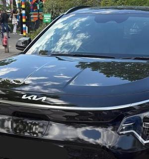 a black car parked on the side of a street