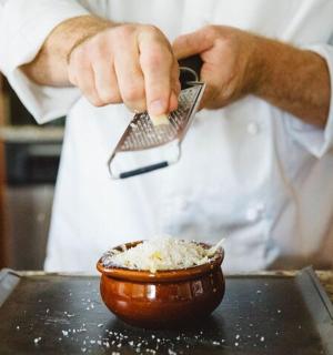 a chef preparing a bowl of food with a spatula