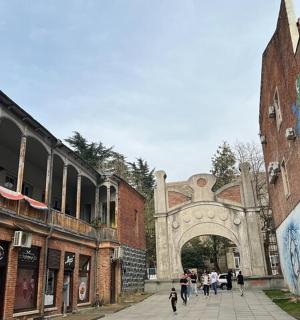 a group of people walking down a street in an alley