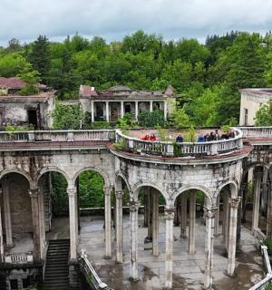 an old building with a bunch of people on a balcony
