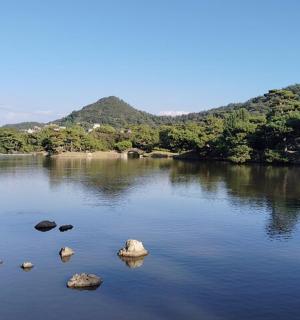 a large lake with rocks in the middle of it