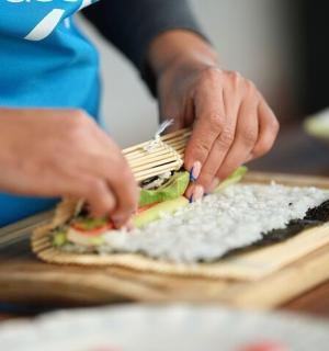 a person making a sandwich on a cutting board