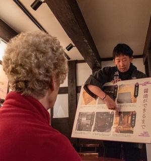 a man reading a newspaper while a man reads a newspaper