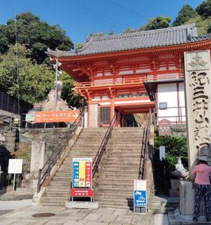a woman standing in front of a building with stairs