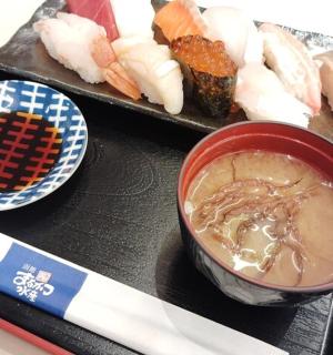 a plate of food with a bowl of food and sushi