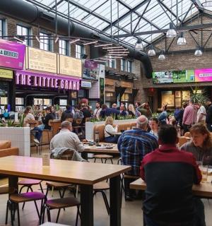 a group of people sitting at tables in a restaurant