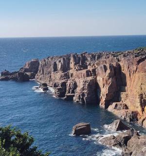 a rocky shoreline with rocks in the water
