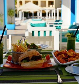 a table with a sandwich and a plate of food