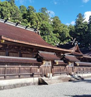 a building with a brown roof and a fence