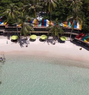 an aerial view of a beach with a boat in the water