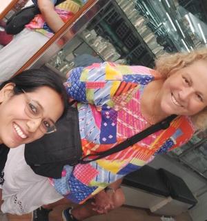 two women are posing for a picture in a store