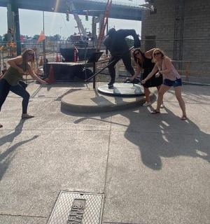 a group of people standing around a statue