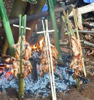 a bunch of food cooking on a fire