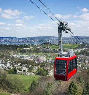 一辆红色电车在城市上空的滑雪缆车上