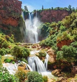 a waterfall in the middle of a canyon