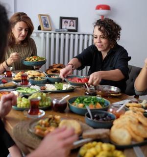 a group of people sitting around a table eating food