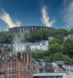 a city with houses and a round building in the background