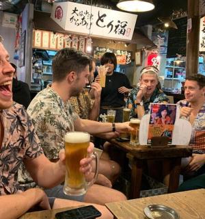 a group of people sitting in a bar drinking beer