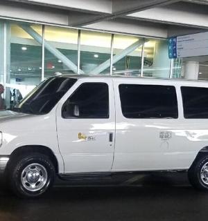 a white van parked in front of a building