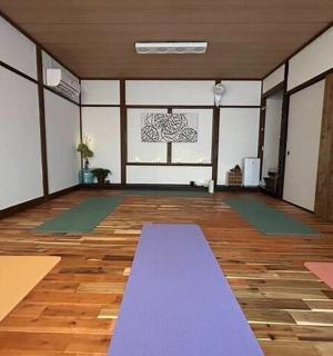 a yoga room with mats on the floor and a window