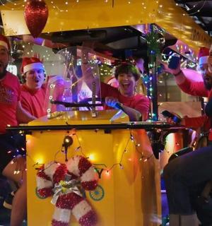 a group of people in santa hats on a carousel