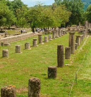 a cemetery with stone posts in the grass