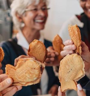 a woman holding up a handful of potato chips
